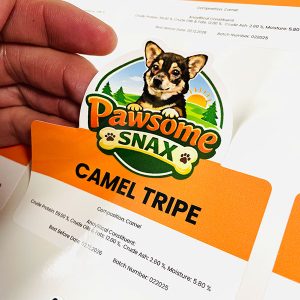 Hand peeling sticker off backing paper