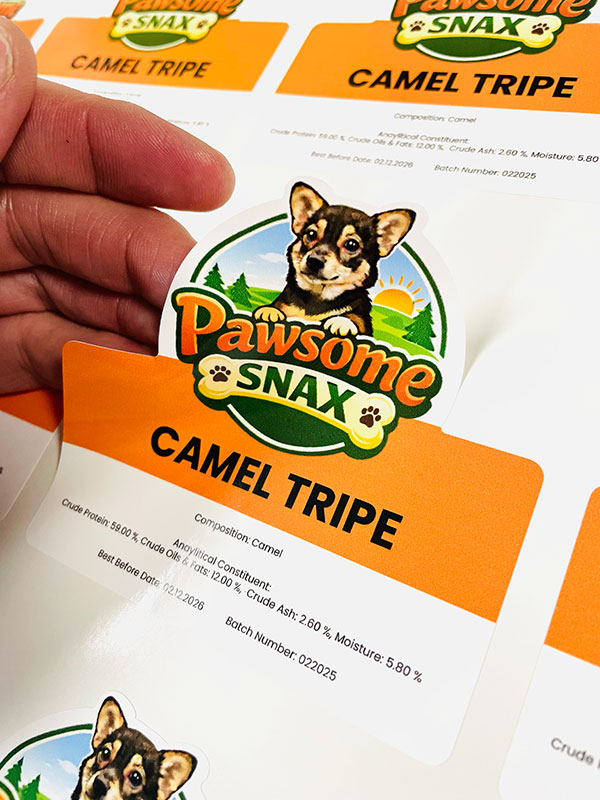 Hand peeling sticker off backing paper